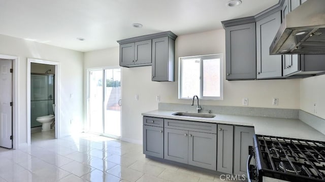 13241 Fairview St, Garden Grove, CA 92843 - kitchen featuring black gas range, wall chimney range hood, light countertops, gray cabinets, and a sink