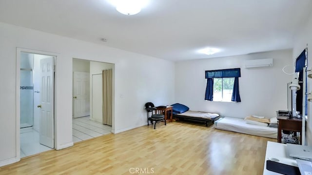 13241 Fairview St, Garden Grove, CA 92843 - living area with baseboards, a wall mounted air conditioner, and light wood finished floors