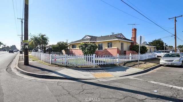 13241 Fairview St, Garden Grove, CA 92843 - view of front of home with brick siding, a fenced front yard, and a chimney