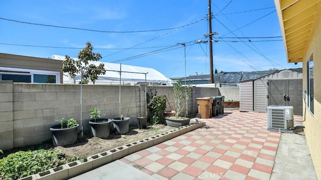 13241 Fairview St, Garden Grove, CA 92843 - view of patio featuring central air condition unit, an outdoor structure, a fenced backyard, and a shed