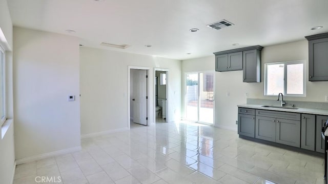 13241 Fairview St, Garden Grove, CA 92843 - kitchen featuring light countertops, gray cabinets, visible vents, and a sink