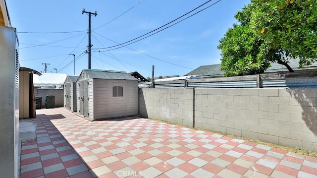 13241 Fairview St, Garden Grove, CA 92843 - view of patio with an outbuilding, a shed, and a fenced backyard