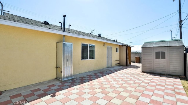 13241 Fairview St, Garden Grove, CA 92843 - rear view of property with an outdoor structure, a shed, a patio area, and stucco siding