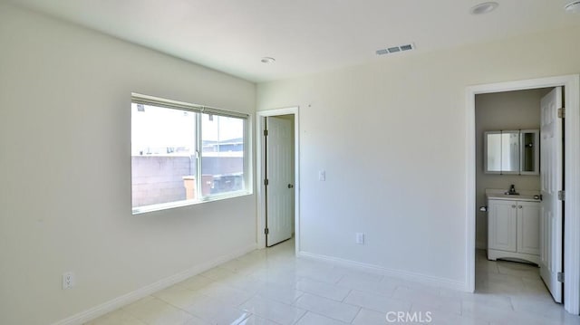 13241 Fairview St, Garden Grove, CA 92843 - unfurnished bedroom with visible vents, a sink, baseboards, and light tile patterned floors