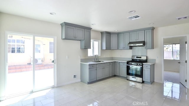 13241 Fairview St, Garden Grove, CA 92843 - kitchen with stainless steel range with gas stovetop, gray cabinets, baseboards, and under cabinet range hood