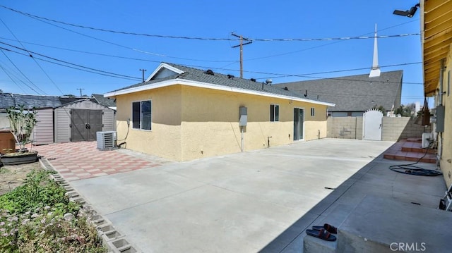 13241 Fairview St, Garden Grove, CA 92843 - rear view of house featuring an outbuilding, fence, a storage unit, a patio, and stucco siding