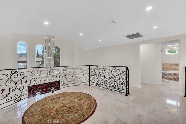 interior space featuring marble finish floor, recessed lighting, baseboards, an upstairs landing, and visible vents