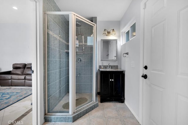 bathroom with vanity, tile patterned flooring, and a shower stall