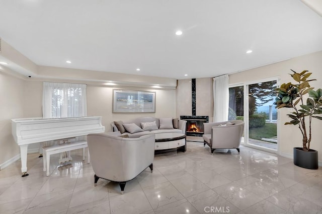 living area with recessed lighting, baseboards, plenty of natural light, and marble finish floor