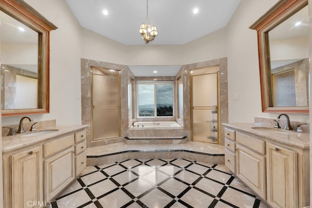 full bath featuring a sink, a bath, and two vanities