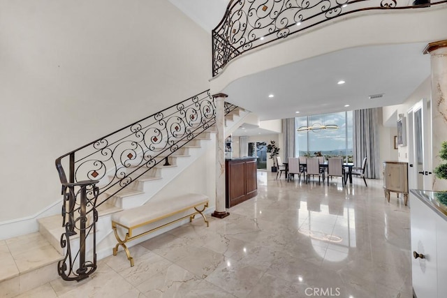 stairway with visible vents and marble finish floor