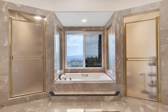 bathroom with a garden tub and a stall shower