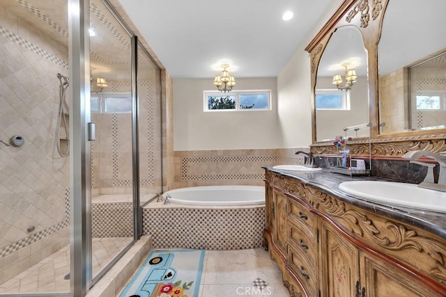 full bath with a garden tub, a sink, a stall shower, and an inviting chandelier