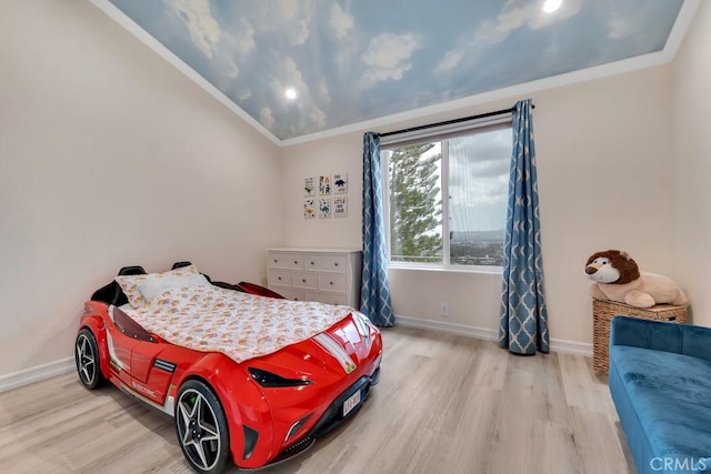 bedroom featuring baseboards, ornamental molding, and wood finished floors