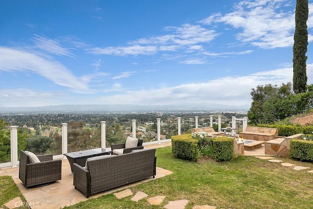 view of yard with an outdoor living space with a fire pit and a patio area