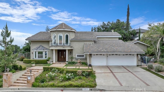 view of front facade with a garage, stucco siding, and concrete driveway