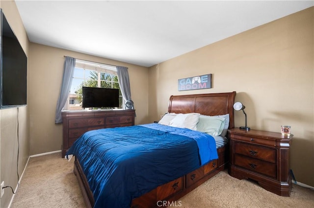 bedroom featuring baseboards and light colored carpet