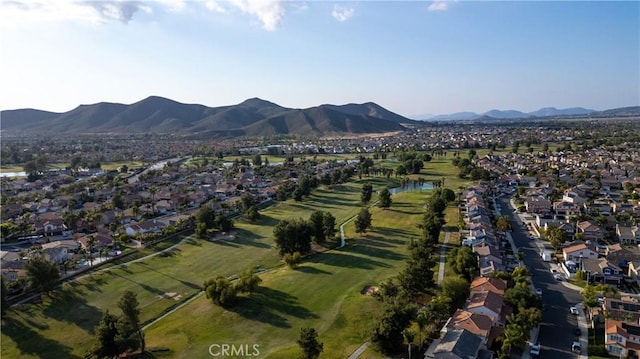 birds eye view of property featuring view of golf course, a residential view, and a water and mountain view