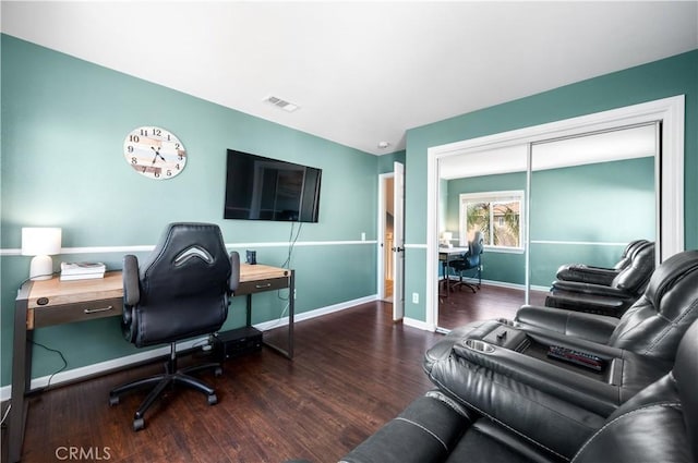 home office with baseboards, wood finished floors, and visible vents