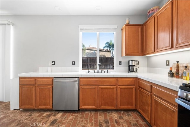 kitchen with a sink, appliances with stainless steel finishes, and brown cabinetry