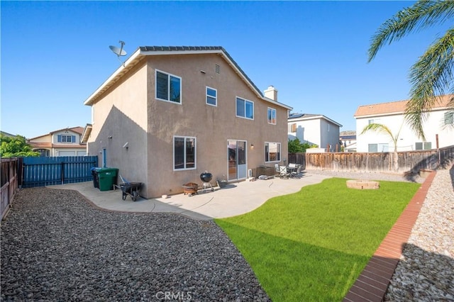 rear view of property featuring a fenced backyard, a patio area, stucco siding, and a yard