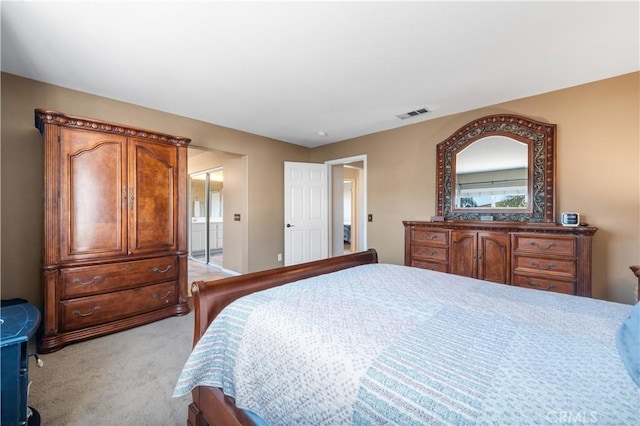 bedroom featuring visible vents and light colored carpet