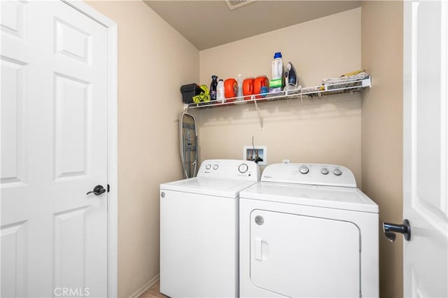 laundry area featuring laundry area, visible vents, and washing machine and clothes dryer