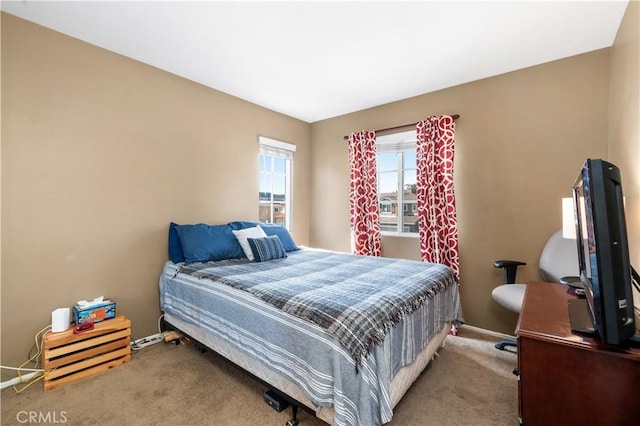 bedroom with carpet flooring and baseboards