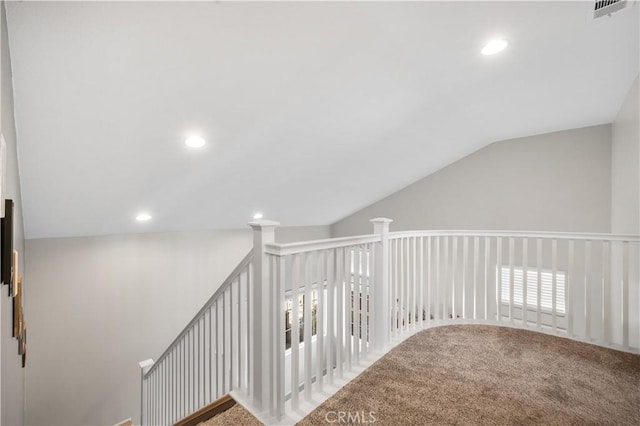 interior space featuring carpet floors, vaulted ceiling, recessed lighting, and visible vents