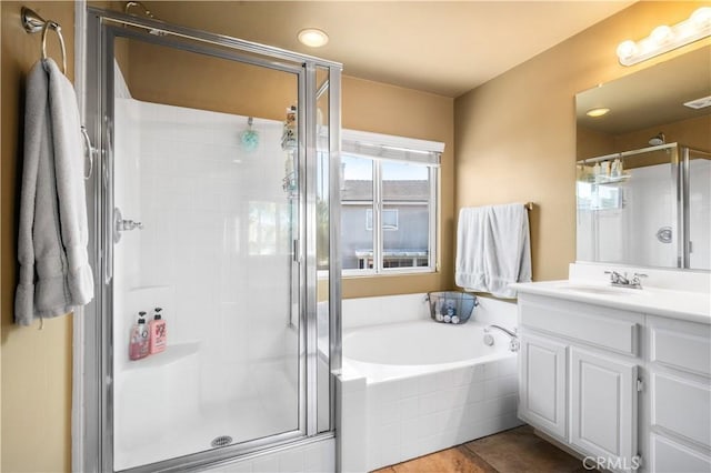 bathroom featuring vanity, a stall shower, tile patterned floors, and a garden tub