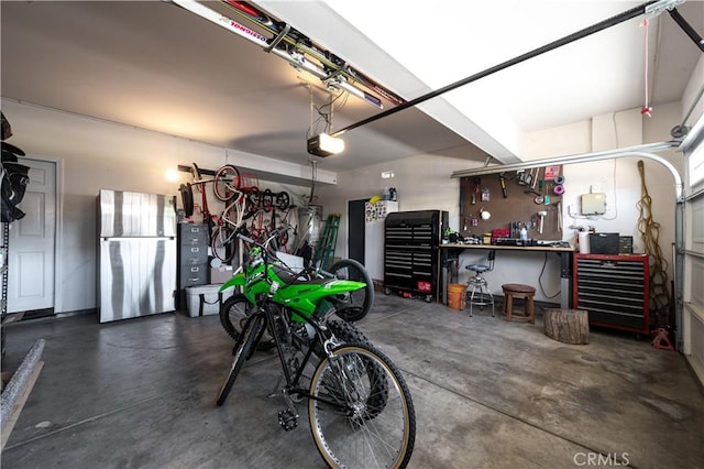 garage with a workshop area and a garage door opener