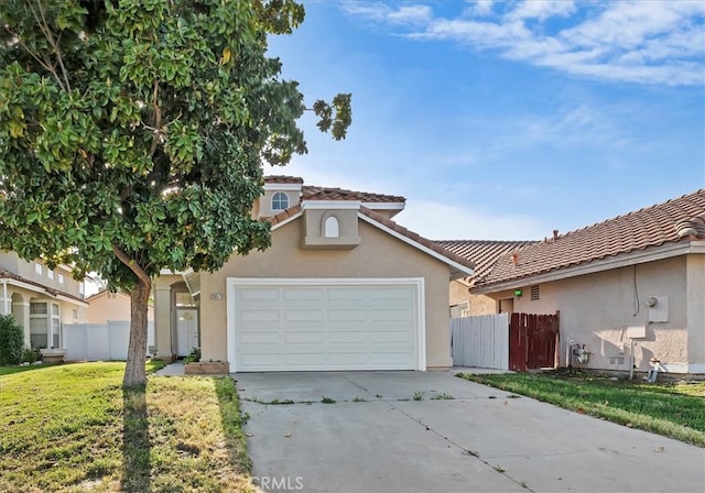 traditional-style home featuring fence, an attached garage, driveway, and stucco siding