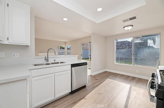 kitchen featuring stainless steel dishwasher, white cabinetry, a sink, and light countertops