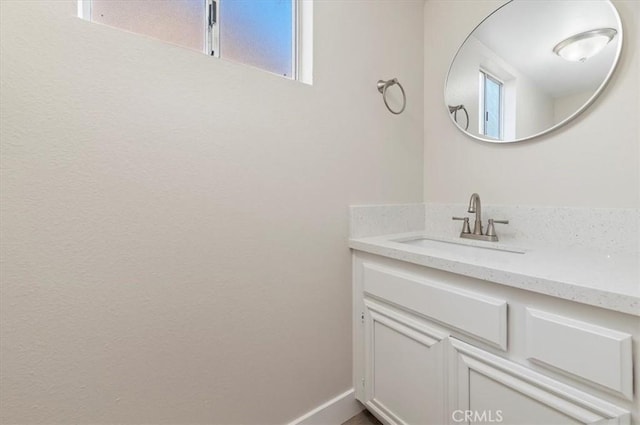 bathroom with vanity and baseboards