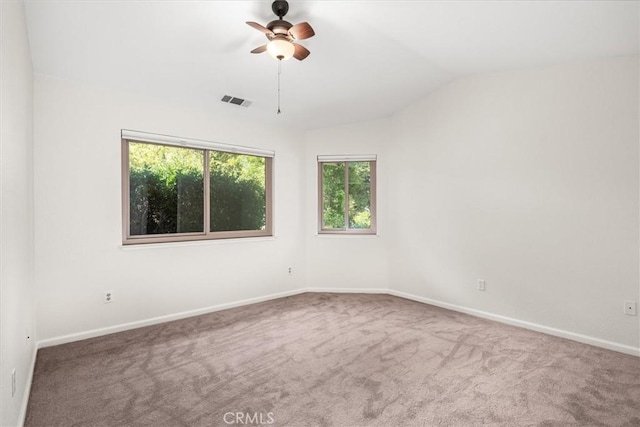 carpeted spare room with baseboards, visible vents, a ceiling fan, and lofted ceiling