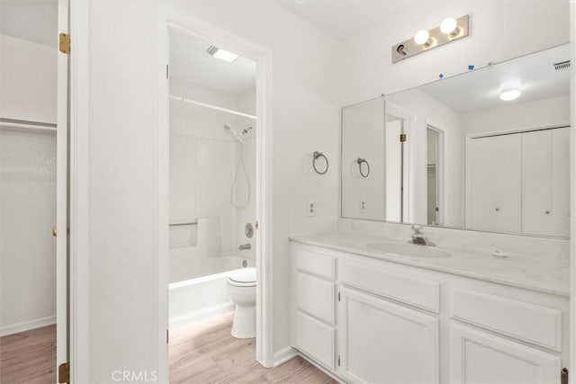 full bathroom with vanity, visible vents, wood finished floors, toilet, and baseboards