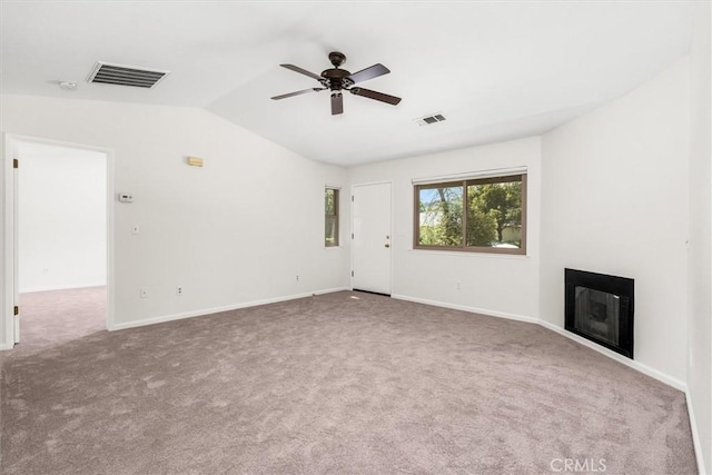 unfurnished living room with visible vents, carpet, ceiling fan, and lofted ceiling