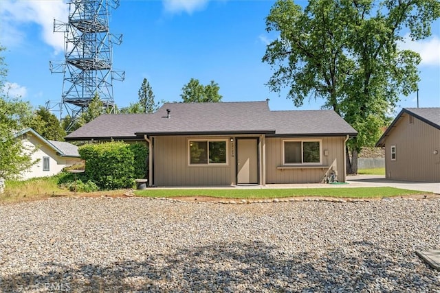 ranch-style home with roof with shingles