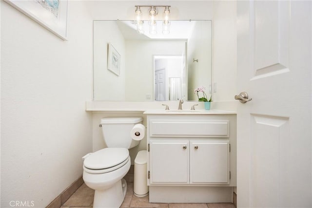 bathroom featuring toilet, baseboards, tile patterned flooring, and vanity