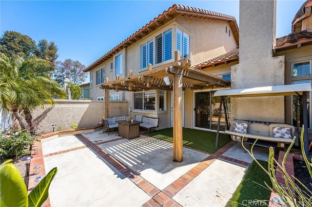 back of property with a patio, outdoor lounge area, stucco siding, and a pergola