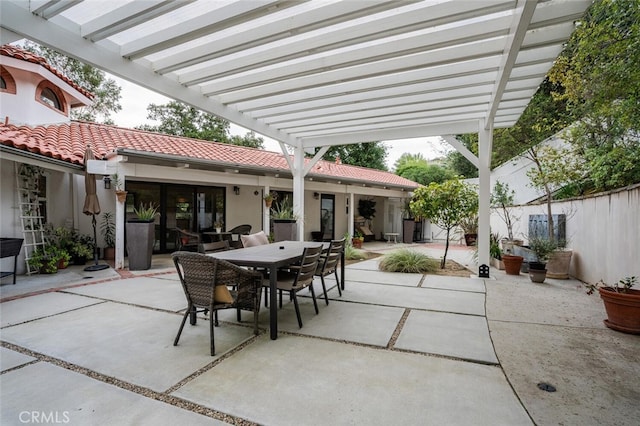 view of patio featuring outdoor dining area, fence, and a pergola