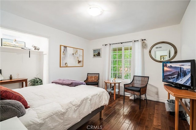 bedroom with baseboards and dark wood finished floors