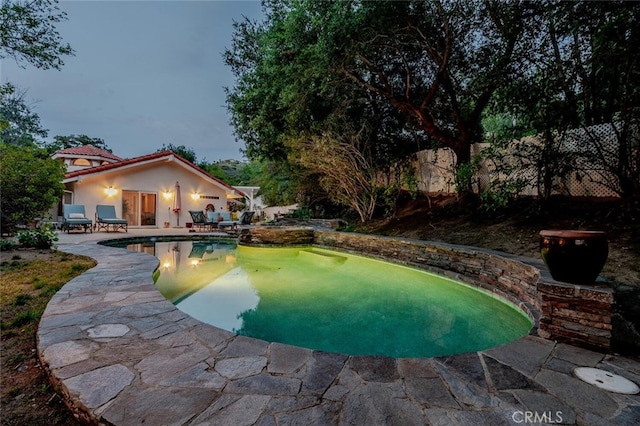 outdoor pool with a patio area