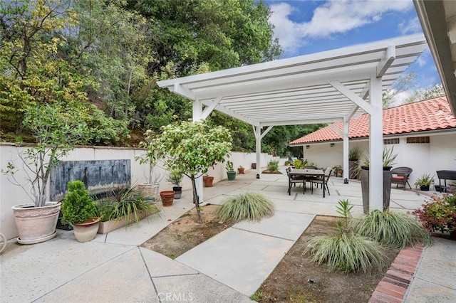 view of patio / terrace with fence, a pergola, and outdoor dining space