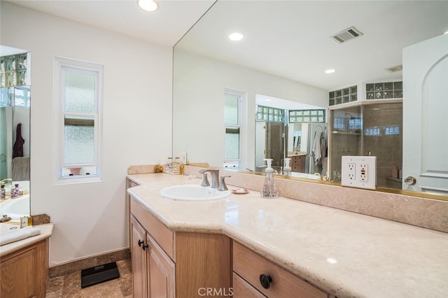 full bathroom with vanity, recessed lighting, baseboards, visible vents, and a stall shower