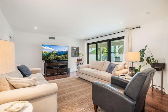 living room featuring baseboards, recessed lighting, wood finished floors, and visible vents