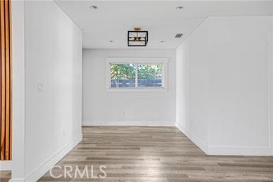 empty room featuring baseboards and wood finished floors