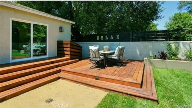 wooden terrace with fence and outdoor dining area