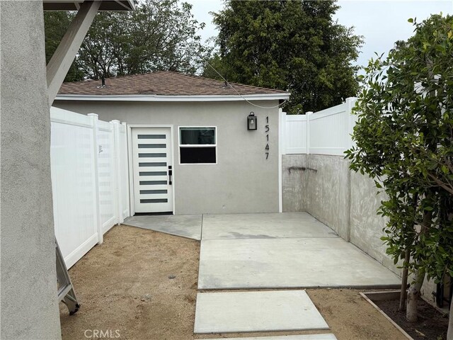 view of outbuilding with fence