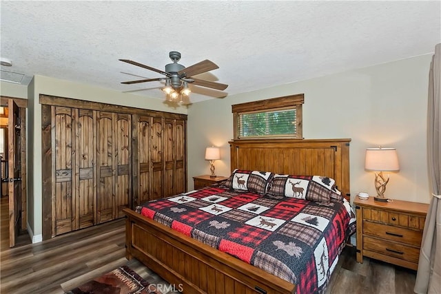 28844 Cedar Dr, Lake Arrowhead, CA 92352 - bedroom with dark wood finished floors, ceiling fan, and a textured ceiling